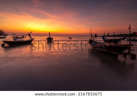 Picture of a fishing boat facing a high oil crisis at sunrise, Thailand