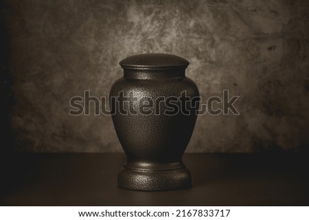 Cremation urn with sepia toning Royalty-Free Stock Photo #2167833717