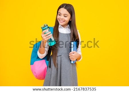 Back to school, student teenager girl with water bottle and holding books and note books wearing backpack. Royalty-Free Stock Photo #2167837535