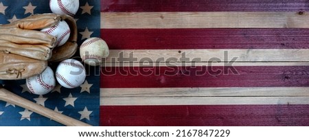 Old baseballs, bat and glove on Wood United States flag background. Baseball sports concept with copy space Royalty-Free Stock Photo #2167847229