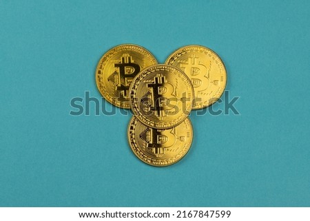 Gold bitcoin coins on blue background, business, money and finance 