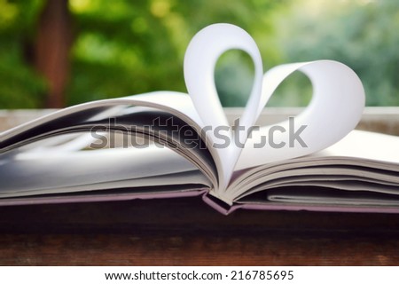 Book pages curved into a shape of heart