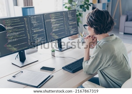 Back view photo of smart professional woman web-designer thinking try optimize improve database in workstation Royalty-Free Stock Photo #2167867319