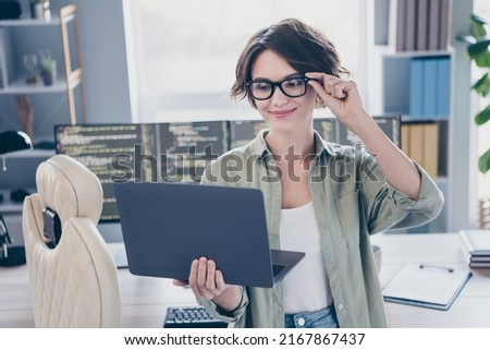 Portrait of pretty positive person arm touch spectacles look netbook read message workstation office
