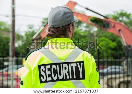 Security guard watching construction site on the street