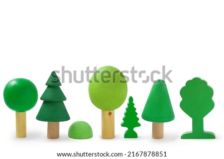 Row with wooden trees isolated on white background.
Children's wooden toys for creativity and skills development. Environmental protection concept. Montessori education. Royalty-Free Stock Photo #2167878851