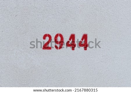 Red Number 2944 on the white wall. Spray paint.
