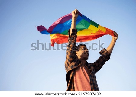 Happy man with a pride flag. LGBT community.	