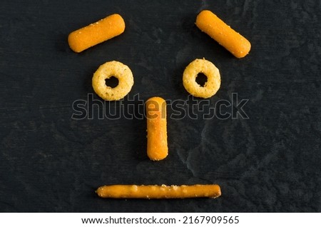 Macro Image of Funny Face Made with Snacks on Dark Background Horizontal