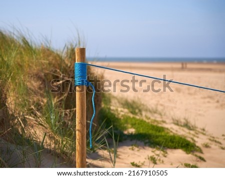 Blue nylon rope on a wooden pole                              