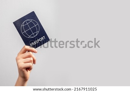 Banner with woman hand holding passport on violet background. Travel concept. Identity, nationality verification. Copy space. High quality photo