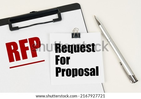 Business concept. On the tablet is a sheet of paper with the inscription - RFP and stickers with the inscription - Request For Proposal, next to the pen. Royalty-Free Stock Photo #2167927721