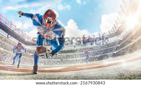 Touchdown in football. Young agile american football player running fast towards goal line. Sportsman in action. Sports emotions. Fans Royalty-Free Stock Photo #2167930843