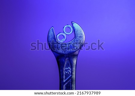 Spanner for 19 made of chrome vanadium steel with the two nuts in between head profile on a violet background. Space for text. Background picture.