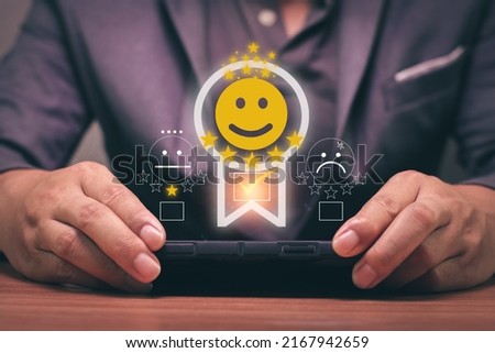 Man is using a smartphone and he is pressing face emoticon smile.