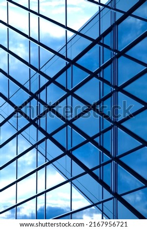 Abstract architecture of modern public or office building. Glass panels and metal frames on ceiling and facade wall. Close-up photo of financial business real estate. Geometric structure of windows.