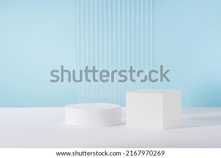 Acrylic ribbed plate, podium, background for cosmetic product packaging on blue backdrop. Showcase for jewellery presentation, display for perfume advertising, cosmetics branding scene mockup