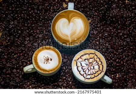 Beautiful Variety of cups of coffee on coffee beans background. flat lay of drink concept.