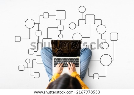 Top view of woman sitting on floor and using laptop with illustration business process and workflow automation with flowchart Royalty-Free Stock Photo #2167978533