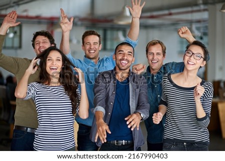 Now thats what I call team spirit. Joyous group of office staff jumping around and having fun together. Royalty-Free Stock Photo #2167990403
