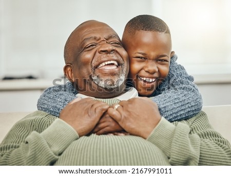 My boy, from my boy. Shot of a grandfather bonding with his young grandson on a sofa at home. Royalty-Free Stock Photo #2167991011