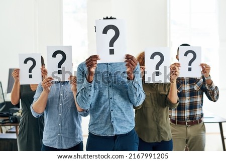 Who How What Where When Why. Shot of a group of businesspeople holding questions marks in front of their faces. Royalty-Free Stock Photo #2167991205