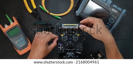 Fiber Optic Fusion Splicing Cable Internet signal and Wire connection with Fiber Optic Fusion Splicing machine fiber optic cable splice machine in work Royalty-Free Stock Photo #2168004961