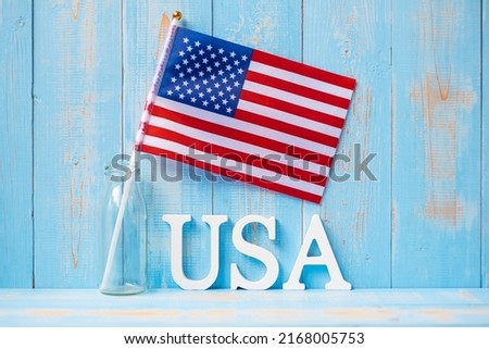 USA text and United States of America flag on wooden table background. concept of Veterans, Memorial, Independence ( Fourth of July) and Labor Day