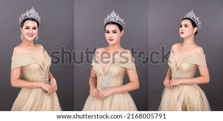 Half Body young adult Asian Woman, look at camera, Miss Beauty Pageant Contest wear Diamond Crown Evening Gown. Beautiful female express feeling smile happy over gray background isolated, copy space Royalty-Free Stock Photo #2168005791