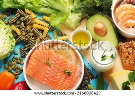 Pescatarian diet on colourful background. Vegetarian diet that includes fish or other aquatic animals. Flat lay, top view Royalty-Free Stock Photo #2168008429