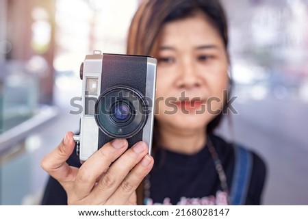 close-up portrait camera phone happy smile;person holding a camera.