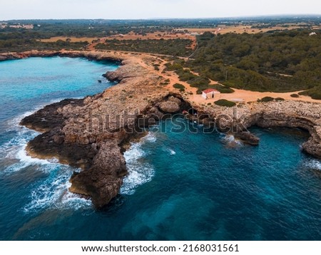 Aerial photography of the incredible landscape of turquoise waters and cliffs of Cala Pardals and Cala PArejals, in Menorca, Balearic Islands. A paradise of blue waters with incredible beaches and cov