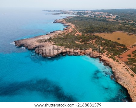 Aerial photography of the incredible landscape of turquoise waters and cliffs of Cala Pardals and Cala PArejals, in Menorca, Balearic Islands. A paradise of blue waters with incredible beaches and cov