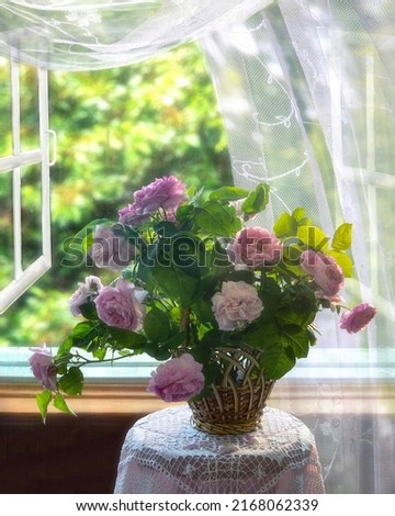 Still life with basket of roses near the window	