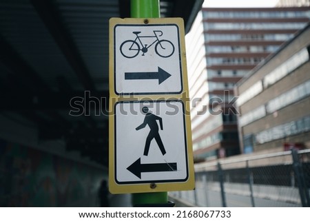 Signs pedestrian arrow and signs bike lane arrow in Boston.