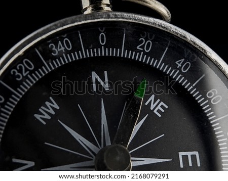 Selective focus.Close-up silver compass on a black background
