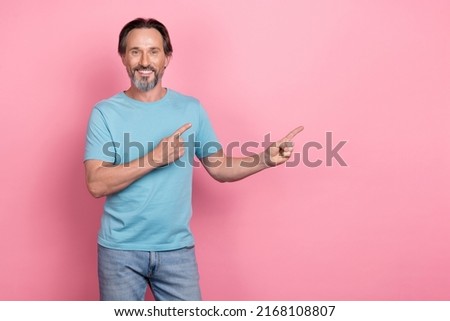 Portrait of cheerful positive person direct fingers empty space ad blank isolated on pink color background