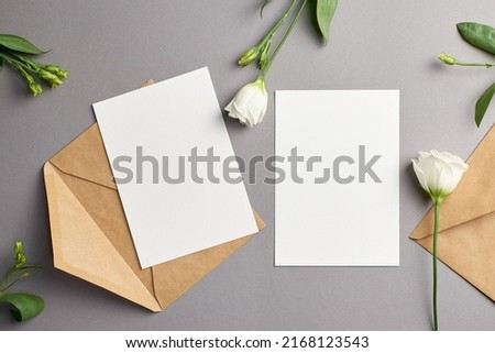 Wedding invitation card mockup with envelope and white eustoma flowers, front and back sides, mockup with copy space