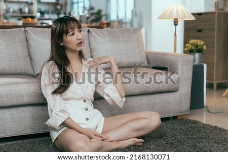korean woman feels uncomfortable in summer and is soaked in sweat. unhappy asian girl fanning herself with hand wishes the heat and humidity can fade away soon. Royalty-Free Stock Photo #2168130071
