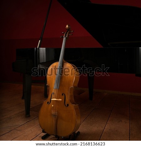 Two classical instruments -  the cello and the grand piano - on a stage waiting for their musicians before a recital Royalty-Free Stock Photo #2168136623