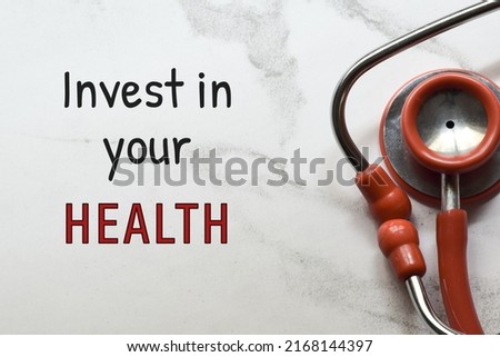 Invest in your health inscription on white background with stethoscope. 