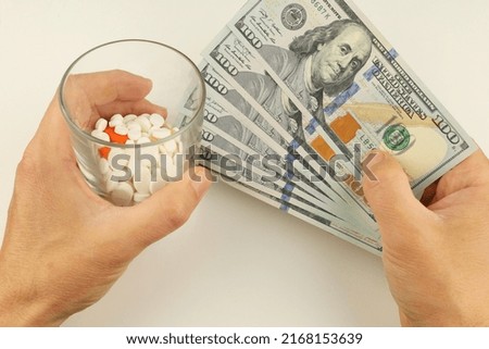 Money and pills in hands