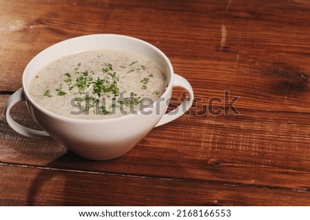 Cream soup on brown wooden board