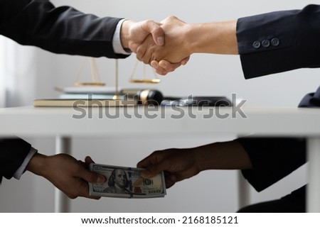 Business people shaking hands and Give an under-the-table bribe to an attorney to help a lawyer win a court case. Bribery and Kickback Ideas Fraud and Fraud Royalty-Free Stock Photo #2168185121