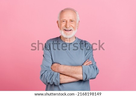Photo of cute funny retired man grey sweater smiling arms crossed isolated pink color background