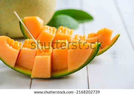 slice of japanese melons, orange melon or cantaloupe melon on white wood background, summer fruits Royalty-Free Stock Photo #2168202739