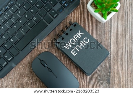 Work ethic text on note pad on top of desk flat lay Royalty-Free Stock Photo #2168203523