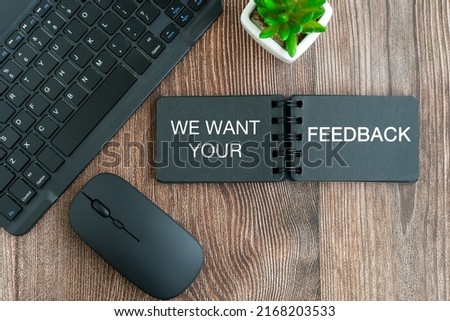 Customer engagement - We want your feed back text on note pad, flat lay