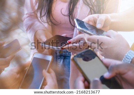 Close up of young people using smartphones - Detail of friends sharing photos on social media network with smartphone - Technology concept and cellphone culture - selective focus