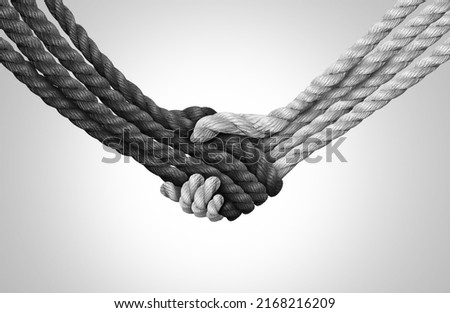 Group Trust concept and connected symbol as different ropes tied and linked together shaped as a handshake or hand shake as a faith metaphor as a trusted partner for support and strength. Royalty-Free Stock Photo #2168216209